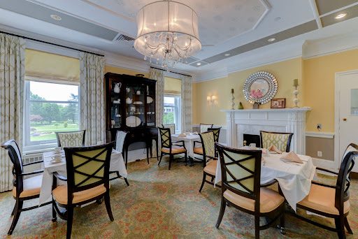 A beautifully designed dining room featuring elegant furniture and a charming chandelier.