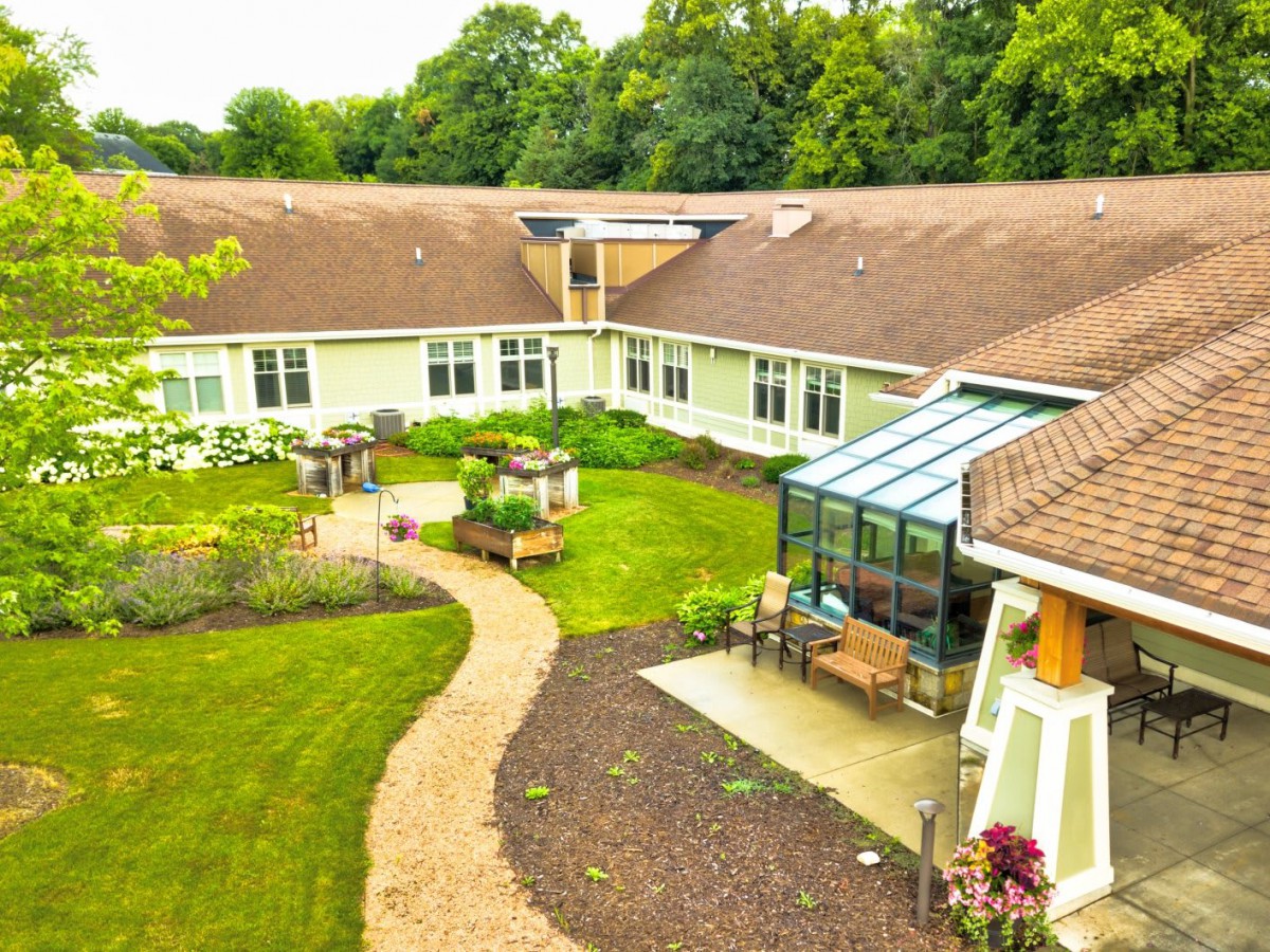 Aerial view of a building with a central courtyard garden and greenhouse.
