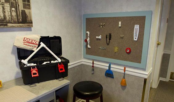 An organized workspace with a toolbox and various tools displayed on a board.
