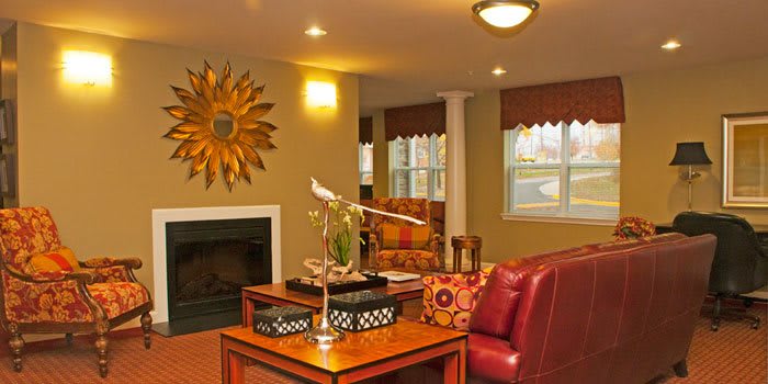 A cozy living room with warm lighting, featuring comfortable furniture and stylish decor.