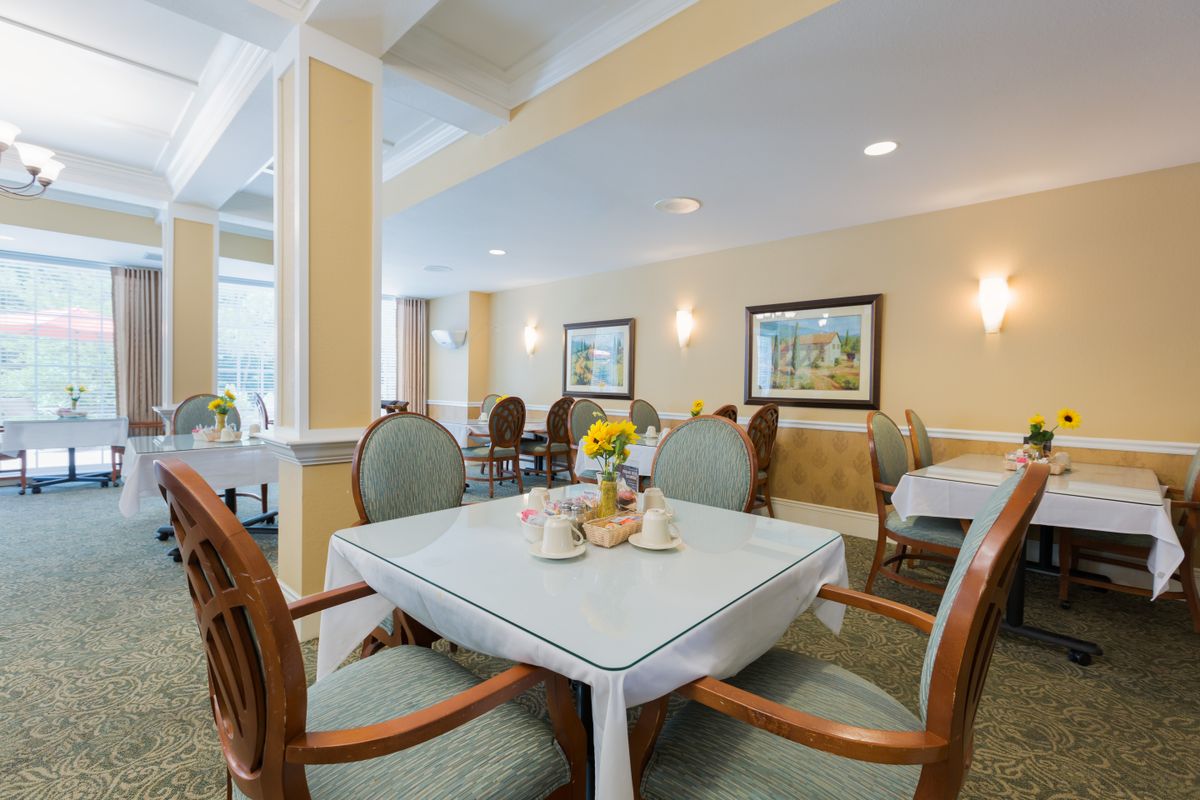 A cozy and elegantly decorated dining room with neatly arranged tables and chairs.