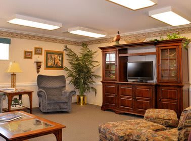 A cozy living room with comfortable seating and a television unit.