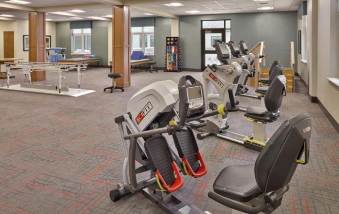 A spacious gym with various exercise machines and fitness equipment.