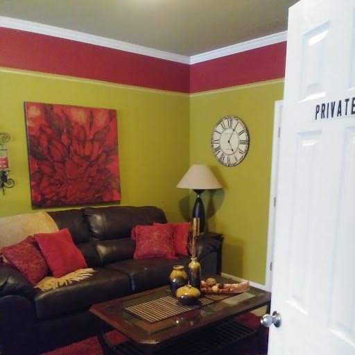 Cozy living room with colorful decor and a private sign on the door.