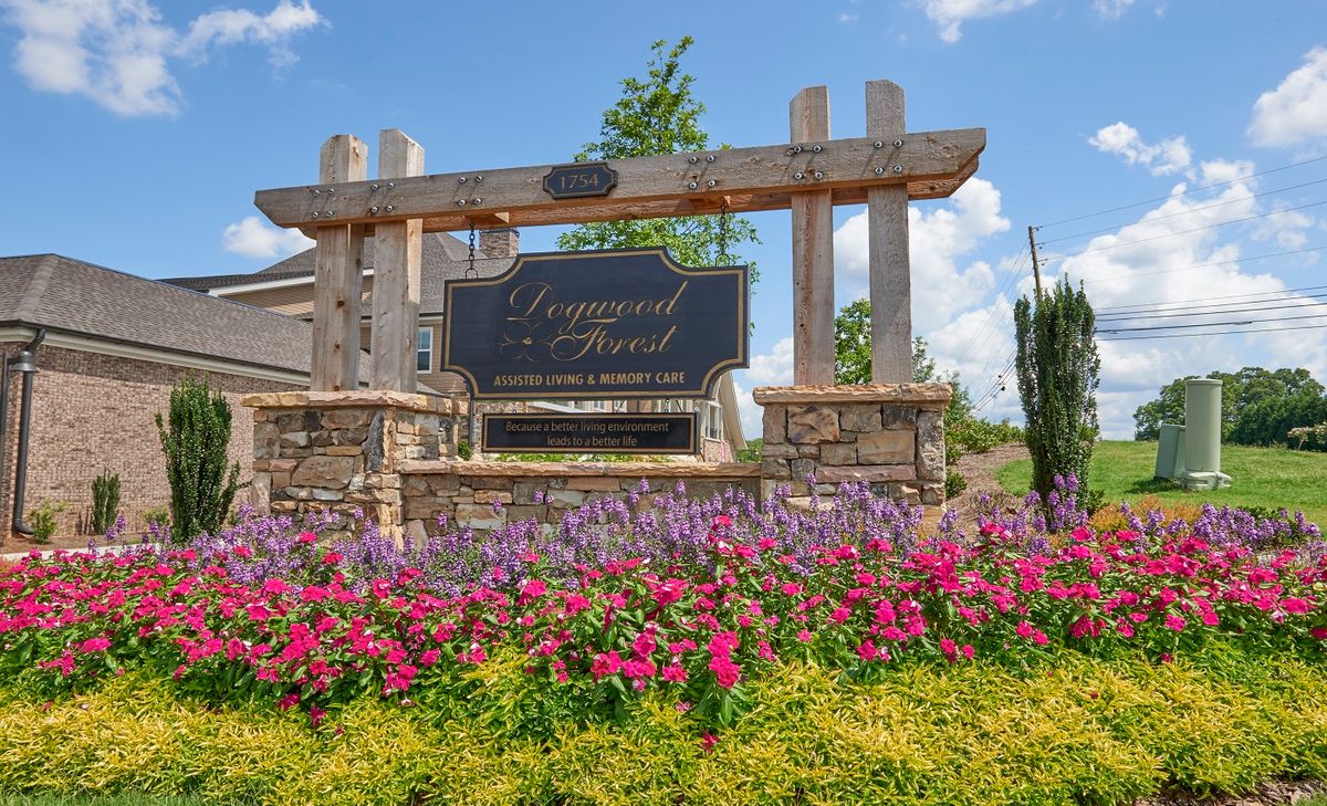 Entrance sign with vibrant flower landscaping.