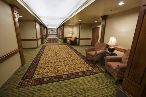 A well-decorated hotel hallway featuring plush seating and elegant carpeting.