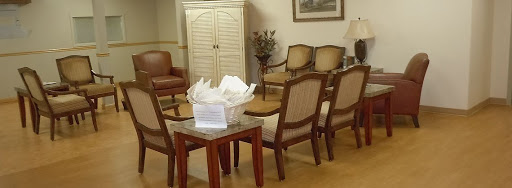 A cozy waiting room featuring comfortable seating and a decorative table.