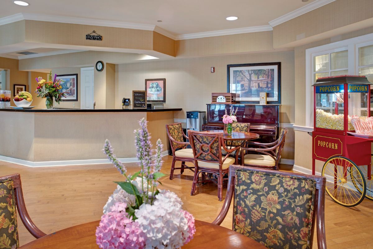 A cozy dining room with elegant furniture and floral decorations.