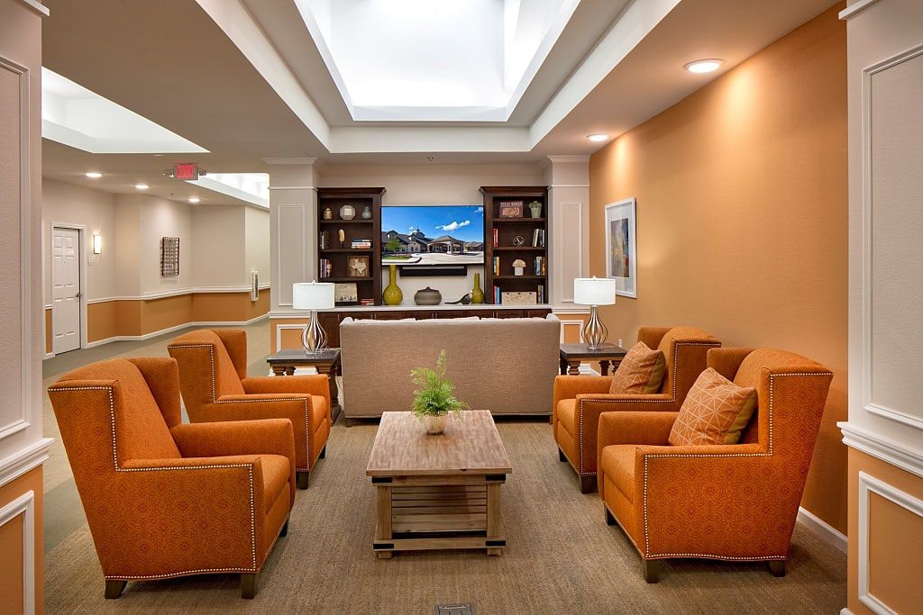 A welcoming lobby area with comfortable orange seating and elegant decor.