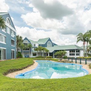 A scenic view of a tropical resort with a swimming pool and lush surroundings.