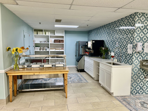 A modern kitchen space featuring decorative walls, ample storage, and a beautifully organized countertop.