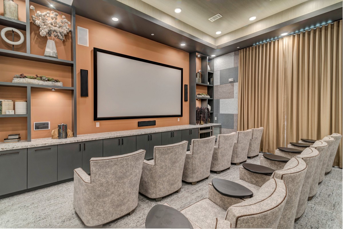 A luxurious home theater setup with a large projector screen and cozy seating.