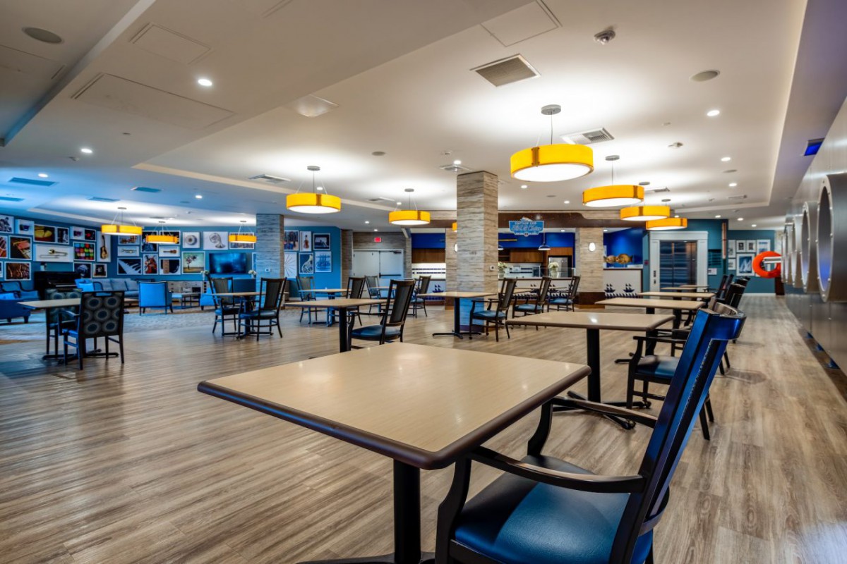 A modern dining area with neatly arranged tables and chairs.