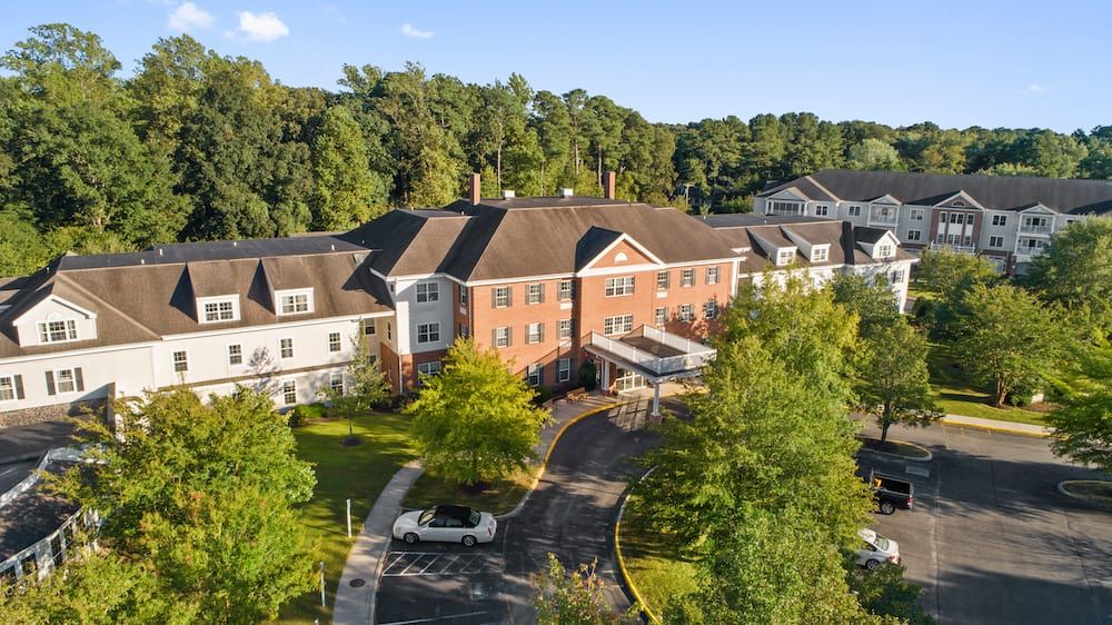 Aerial view of a large building surrounded by trees.