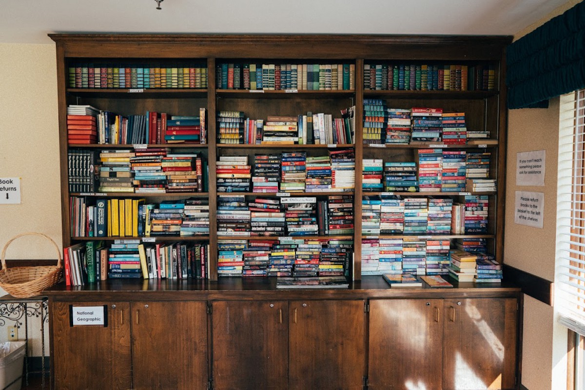 A densely packed bookshelf filled with a variety of books.
