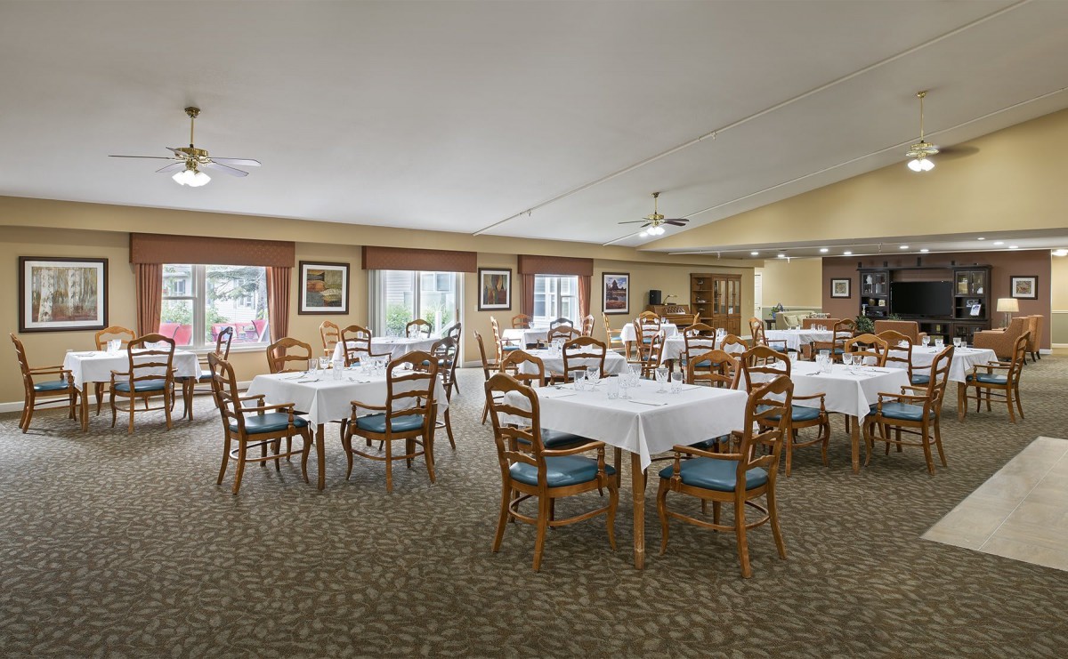 Spacious dining room with neatly arranged tables and chairs.