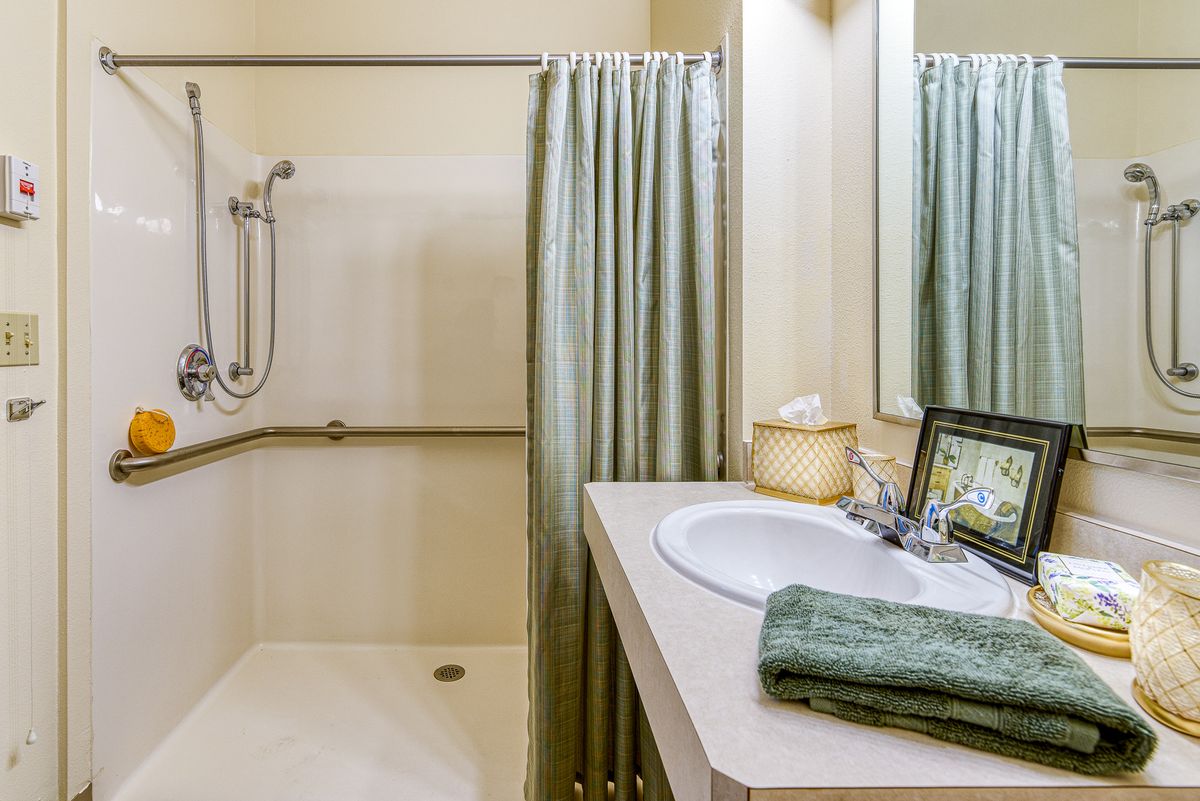 A well-organized bathroom with a shower area and a neatly arranged sink.