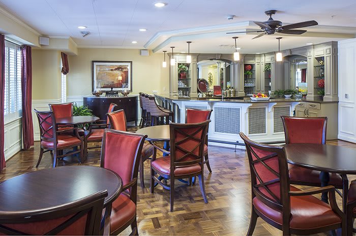 Elegant restaurant dining area with tables and a bar counter.