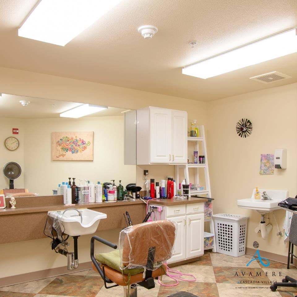 A cozy beauty salon with mirrors, chairs, and hair products neatly arranged.