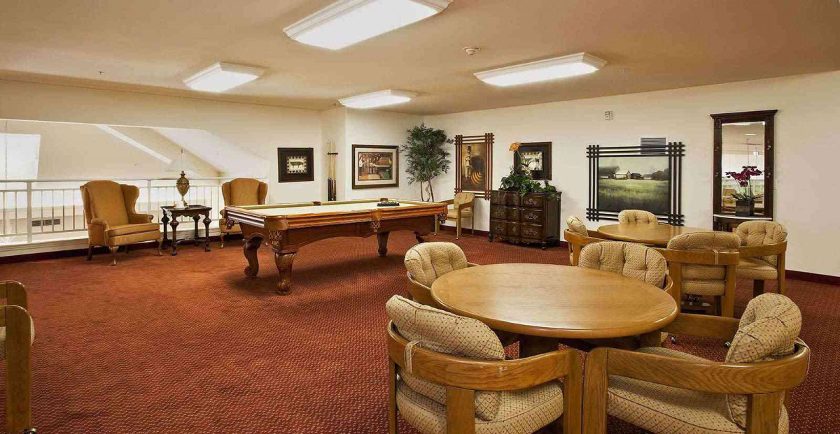 A cozy game room featuring a pool table and seating area.