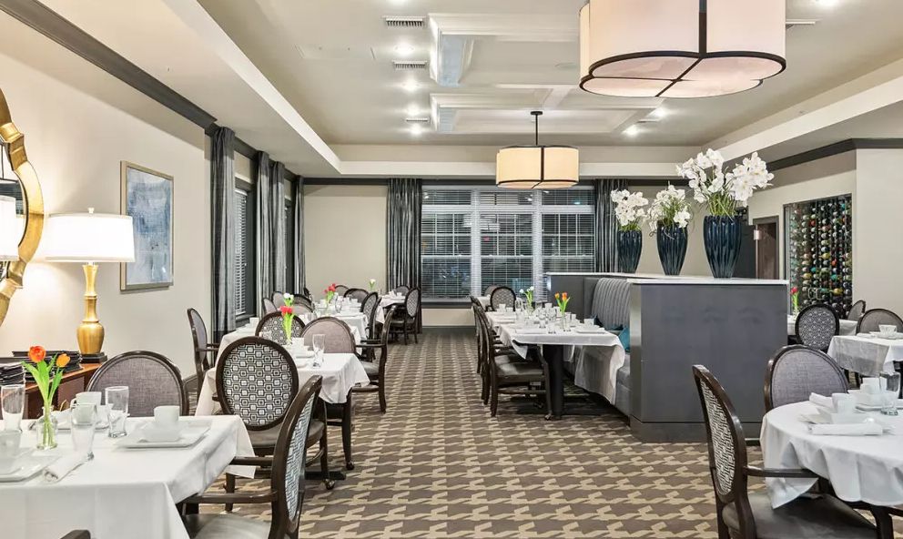 An elegantly decorated restaurant dining room with neatly arranged empty tables.