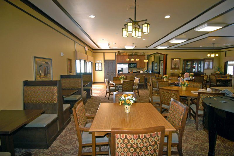 A cozy dining area with wooden tables and decorative lighting.
