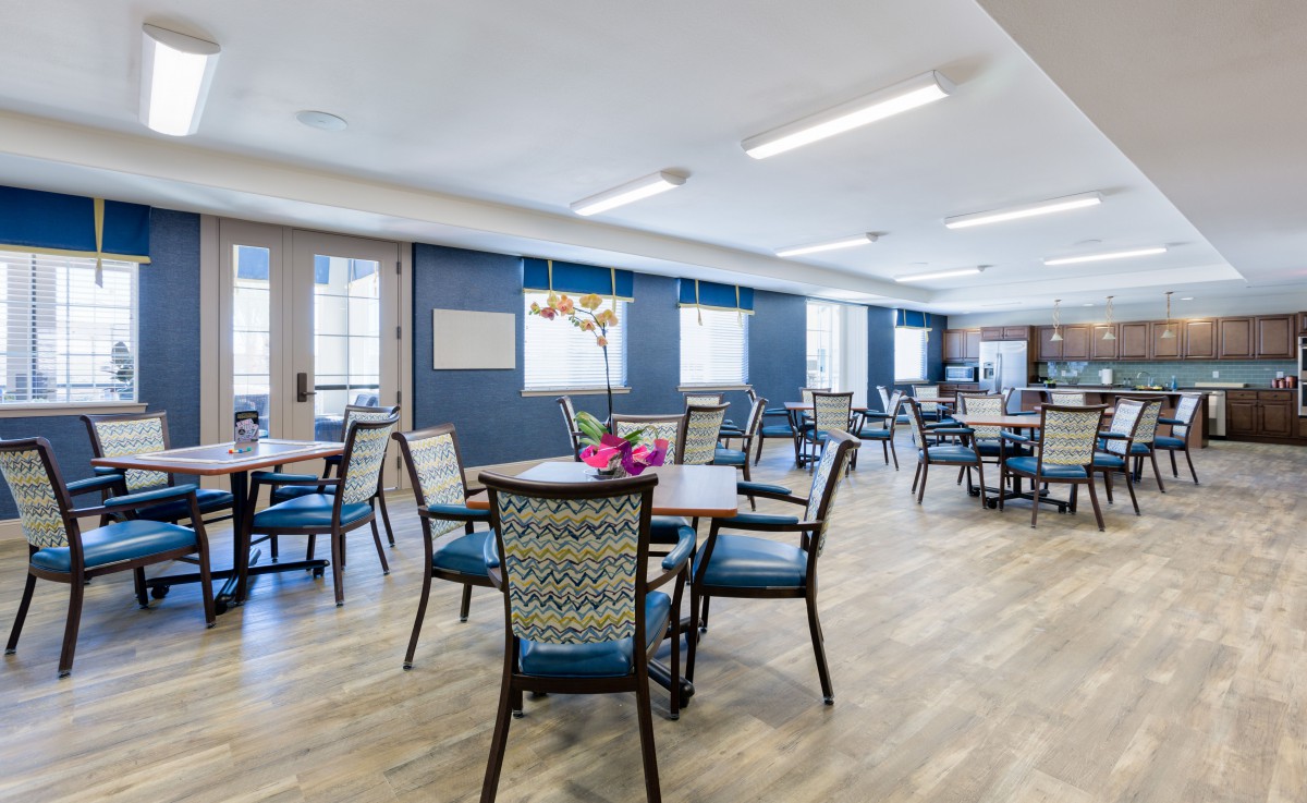 A modern dining area with neatly arranged tables and chairs.