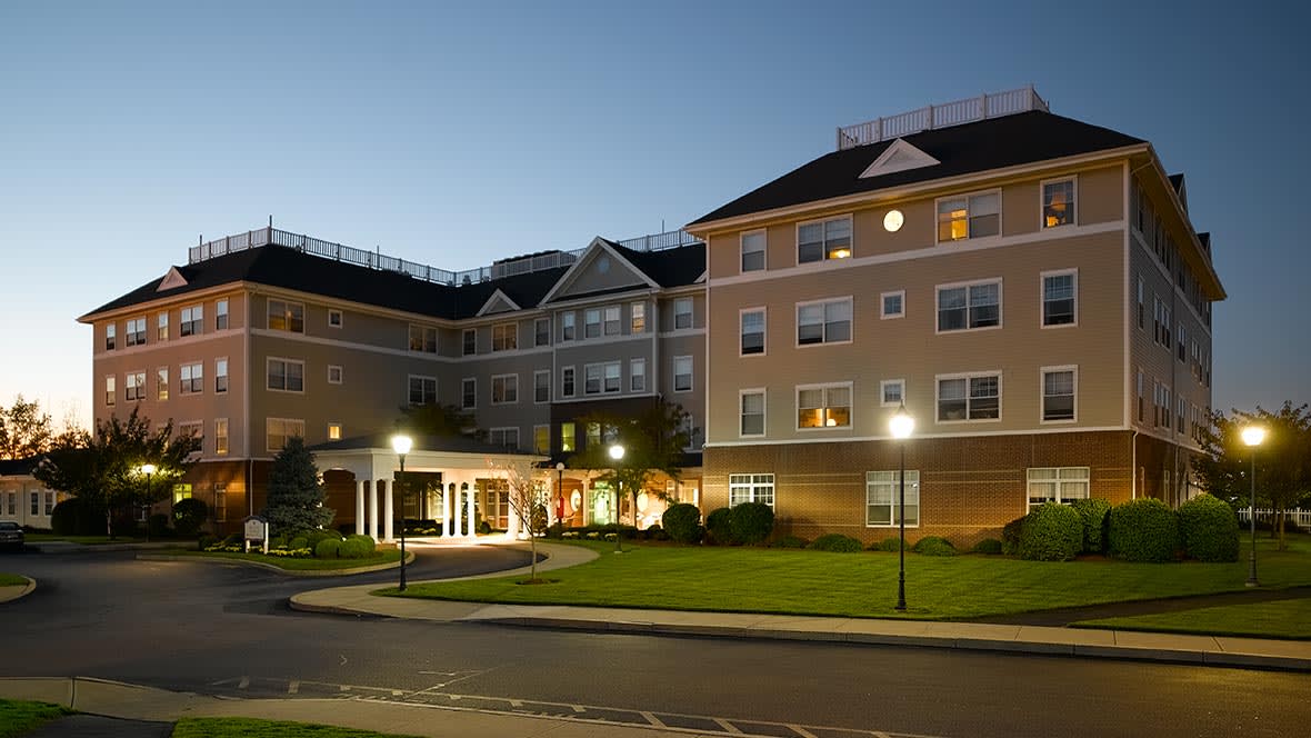 Illuminated hotel building exterior at night.
