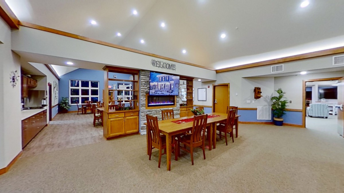 A well-lit dining area with wooden furniture and an open layout.