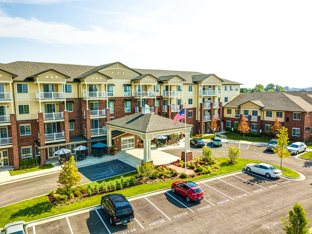 A large apartment complex with a spacious parking lot and landscaped surroundings.