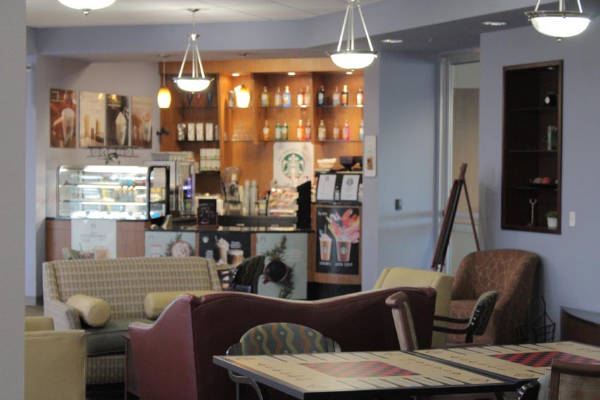 A cozy cafe interior with comfortable seating and a well-lit counter area.