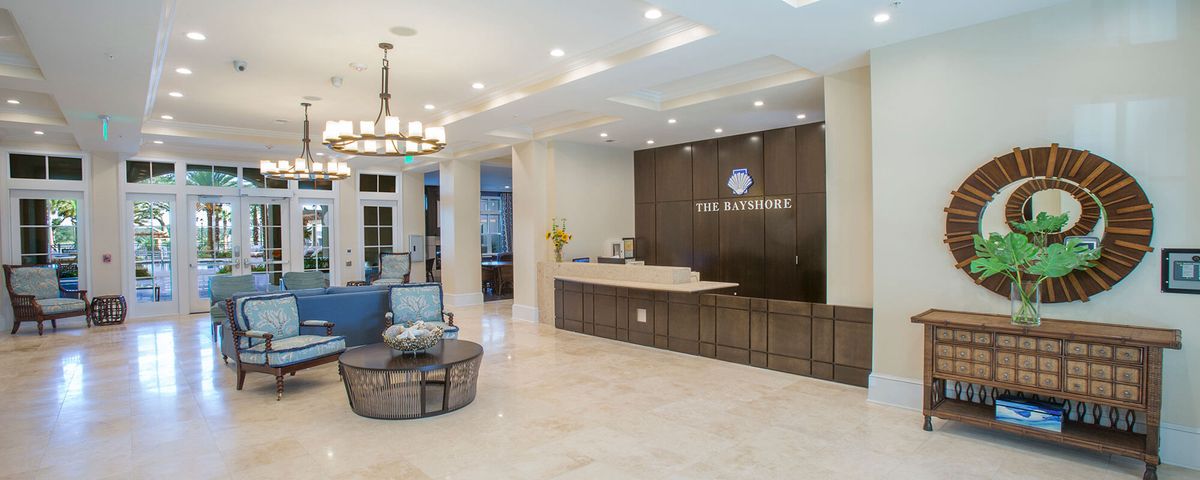 A modern hotel lobby with a reception desk and elegant decor.