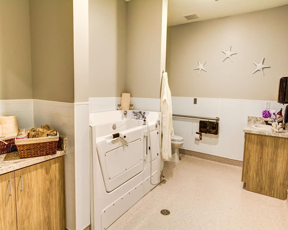 A cozy laundry room featuring a washer and dryer with a laundry basket on the side.