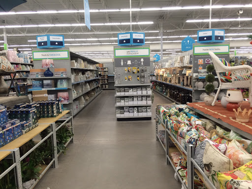 An aisle in a retail store displaying various home goods on the shelves.