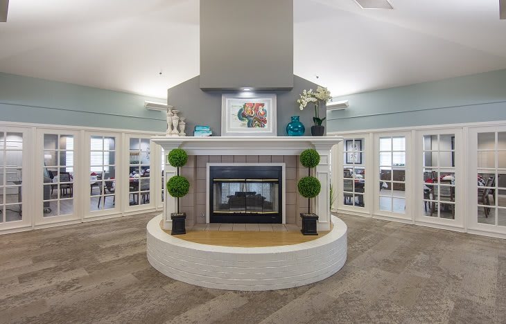 A modern living room with a central fireplace and elegant decor.