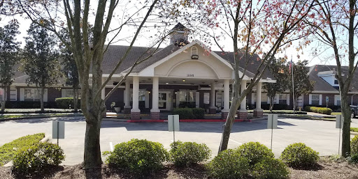 A welcoming entrance to a building surrounded by greenery.