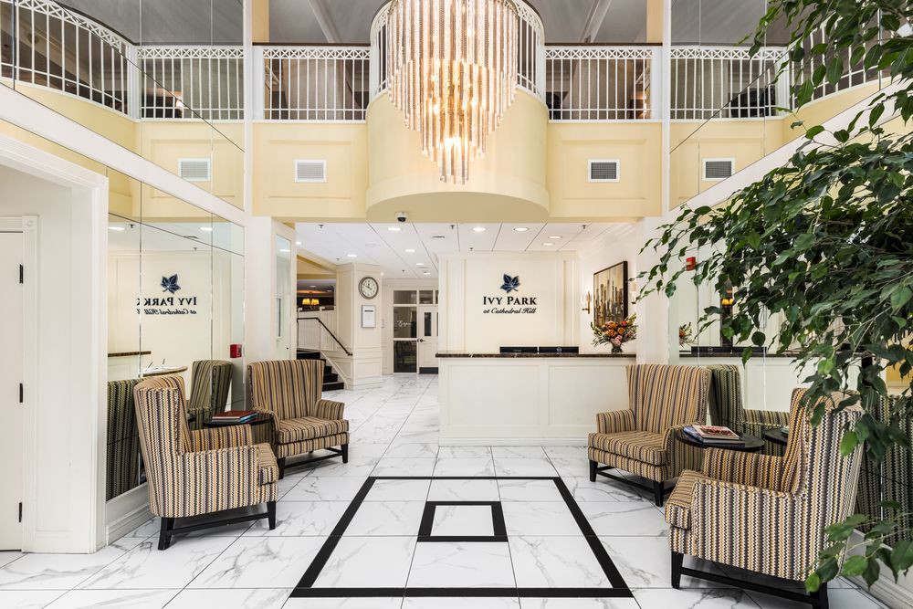 Elegant hotel lobby with a grand chandelier and comfortable seating area.