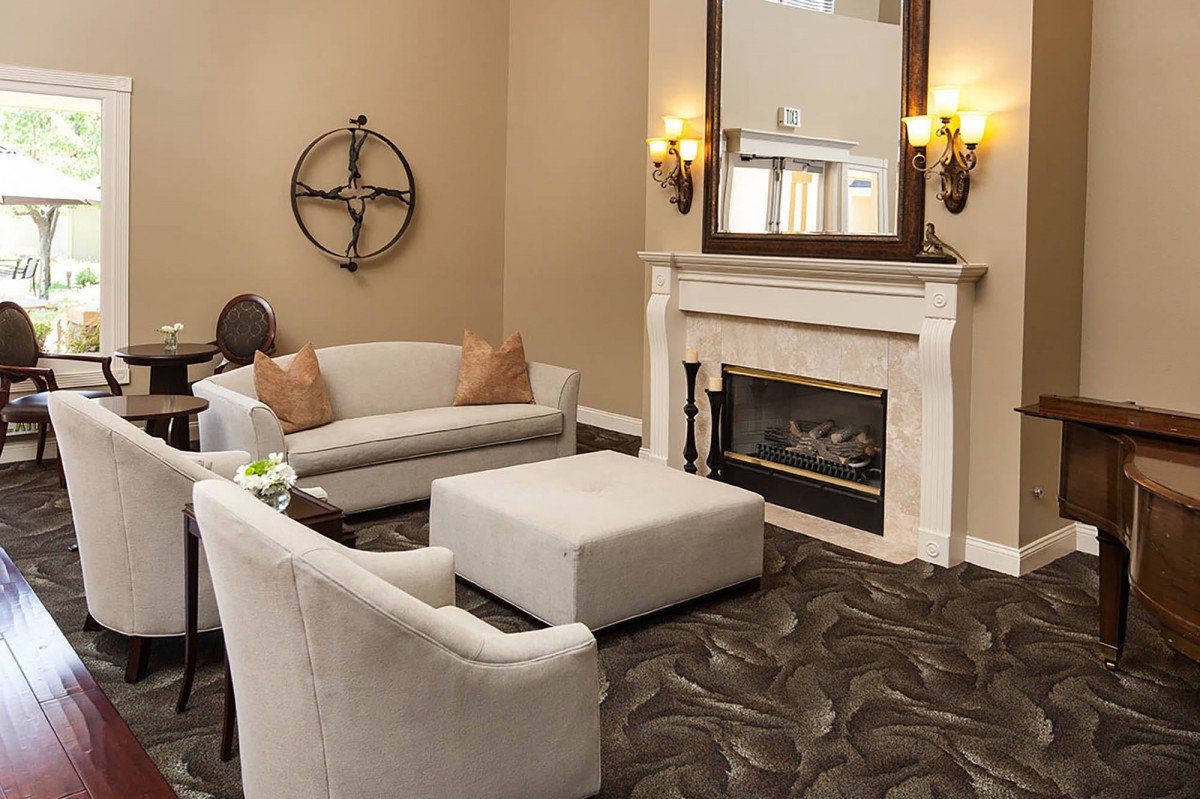 A cozy living room featuring a fireplace, sofas, and elegant decor.