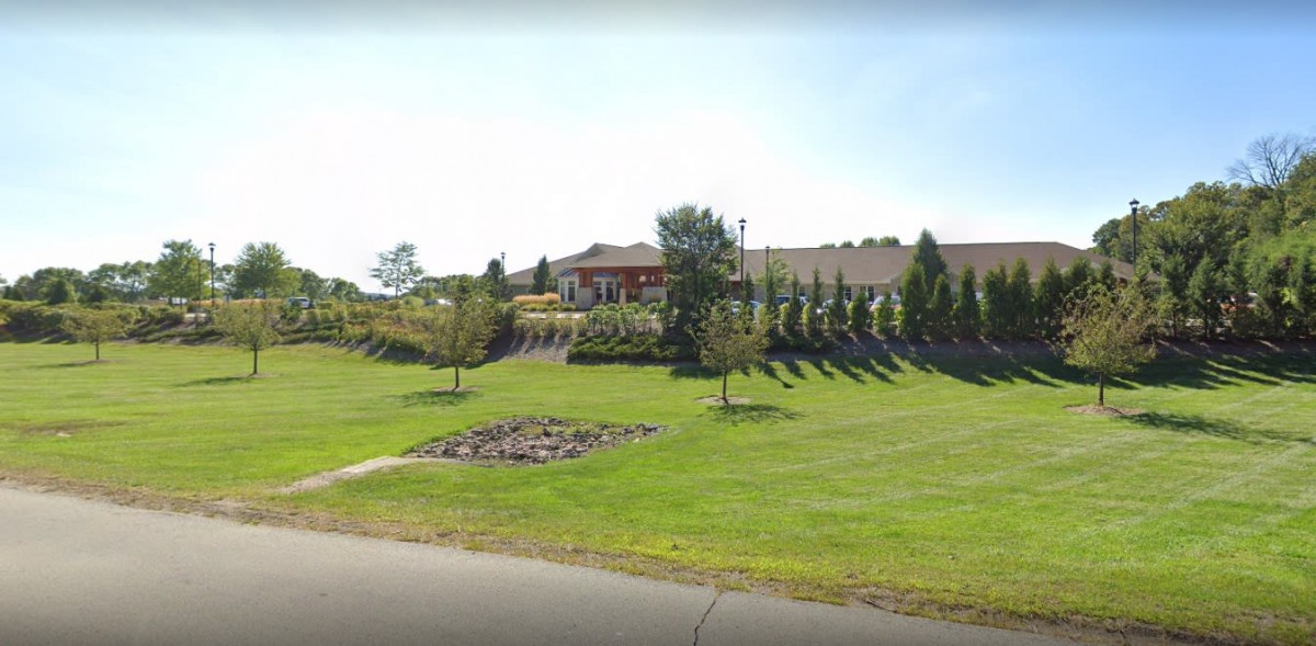 A suburban house with well-maintained landscaping and a spacious lawn.