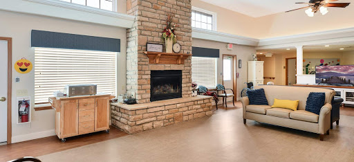 A cozy living room featuring a stone fireplace and ample seating.