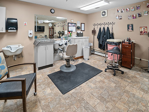 A well-organized barber shop interior featuring a central styling chair and various grooming tools.