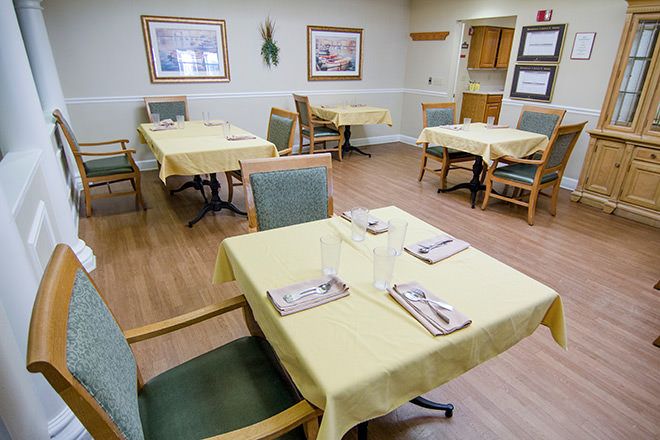 A neatly arranged dining room with tables set for guests.