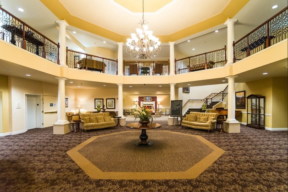 A luxurious lobby with a grand chandelier, elegant seating areas, and decorative elements.