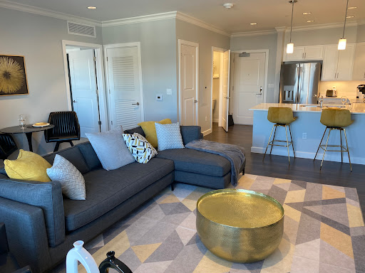 A cozy and modern living room featuring a stylish sofa and a gold coffee table.