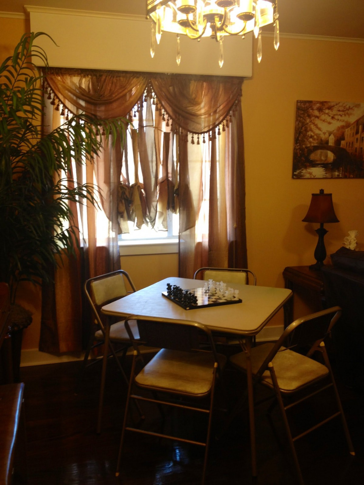 Cozy dining area with a table, chairs, and warm lighting.