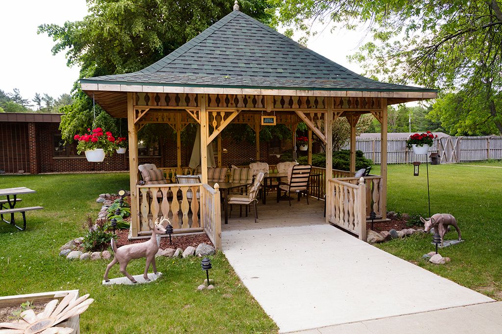 A charming garden gazebo with comfortable seating and lush surroundings.