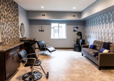 A modern hair salon interior with stylish chairs and decor.