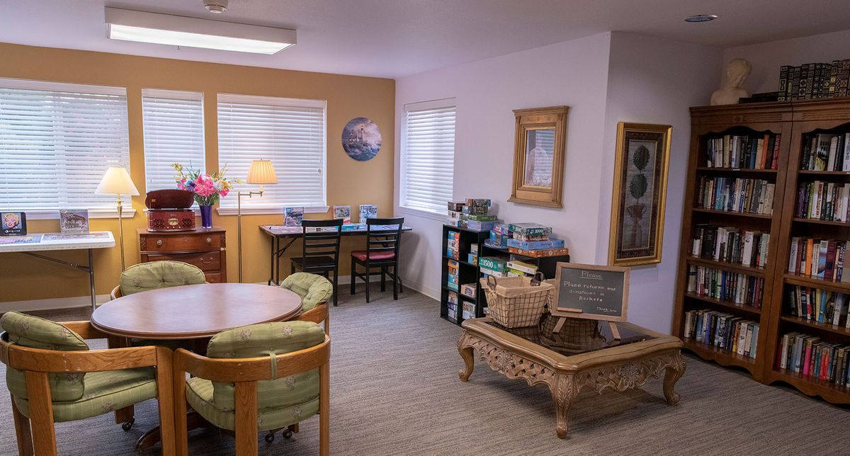 A cozy living room with various seating arrangements and decor.