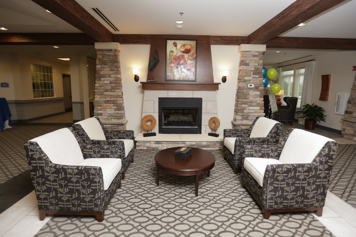A modern living room with a fireplace and elegant seating arrangement.