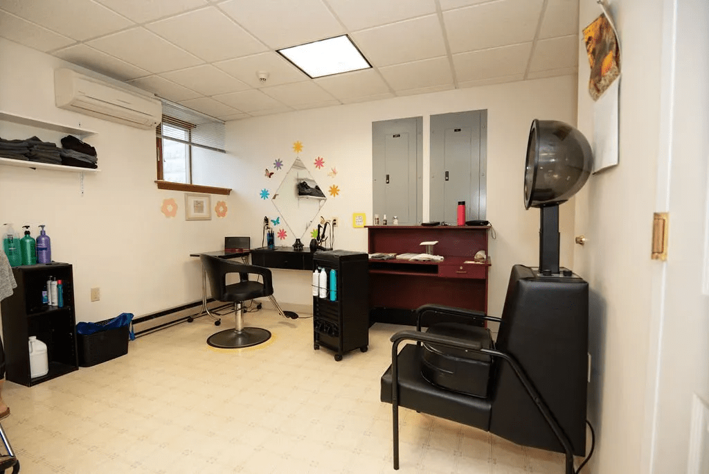 A cozy hair salon with styling chairs and mirrors, ready for customers.